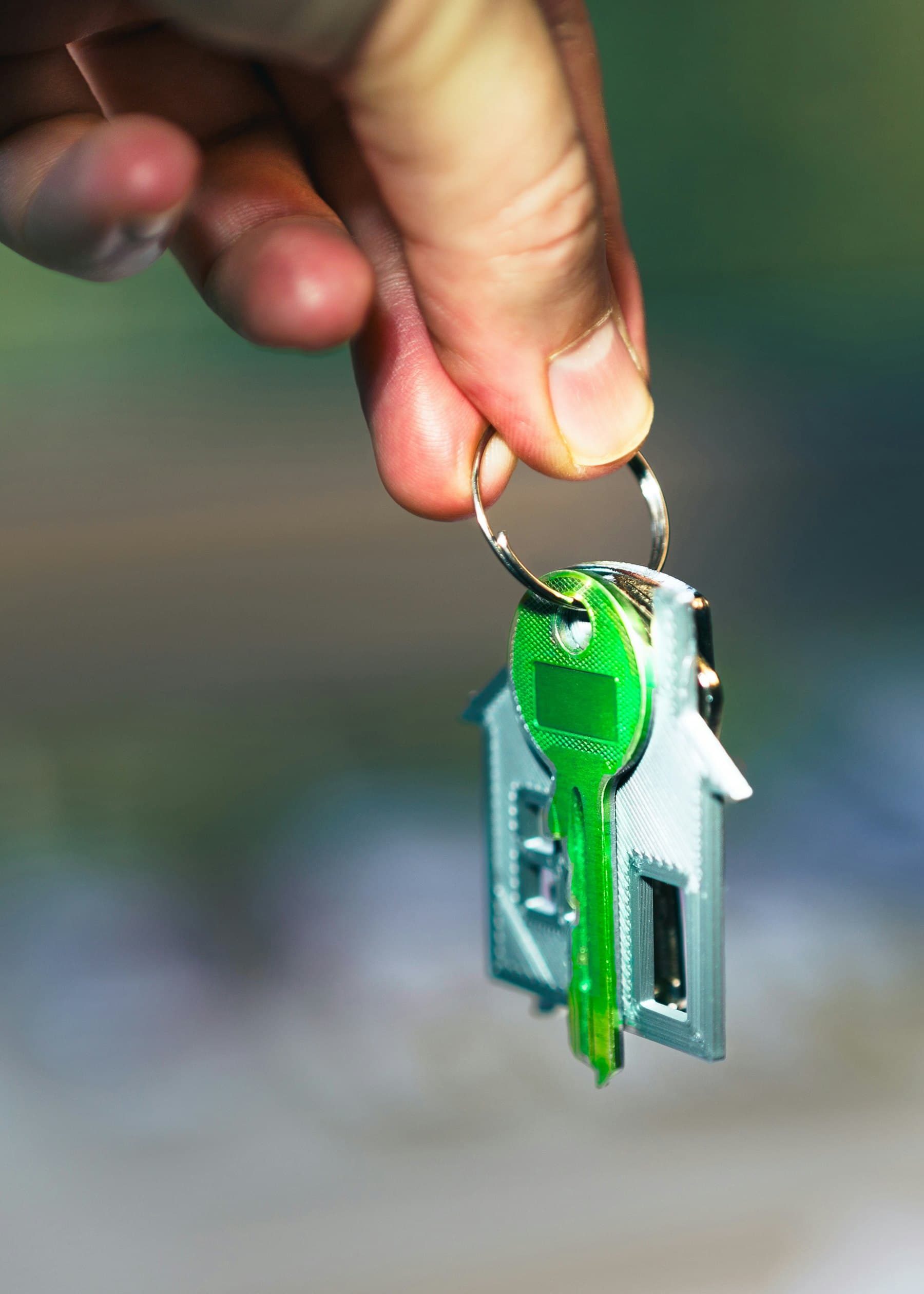 Hand holding a house key